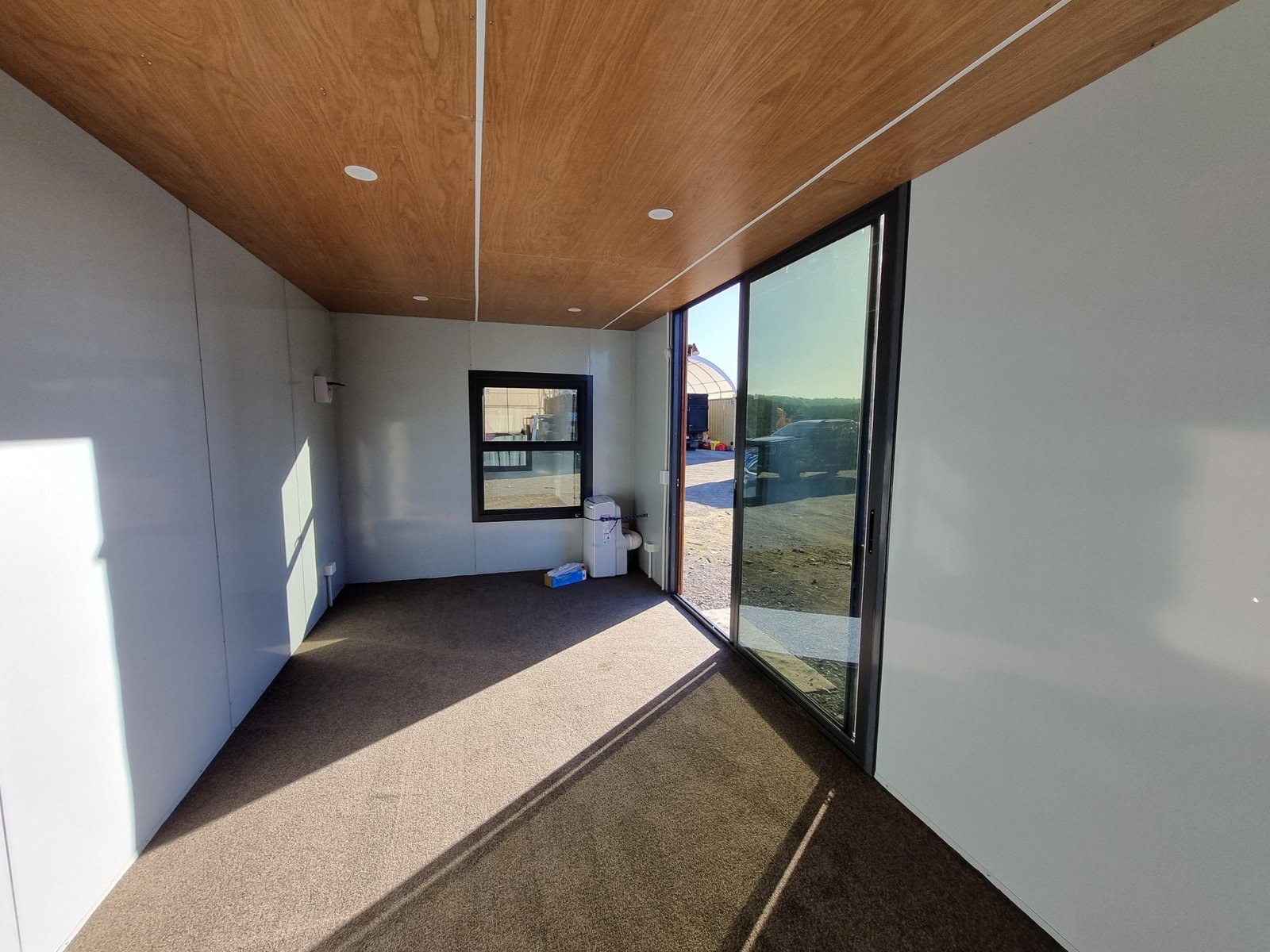 Donald 6m cabin interior with timber-look ceiling and quality carpet